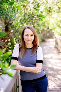 Kate Williams stands in a mangrove forest.